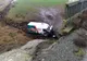 FOTO Accident cu o victimă încarcerată, Mașină căzută în râpă